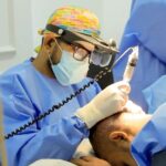 Dr. Tharindu performing a hair transplant procedure